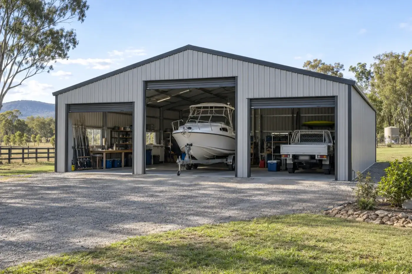 A large shed housing a boat, a ute and a workshop bay